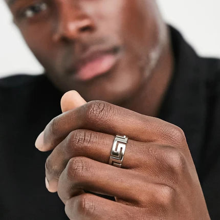 Stainless steel Greek cutout key pattern ring by TMJ, featuring intricate key-shaped design on polished band.