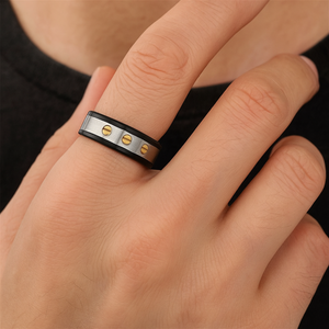 Sleek stainless steel ring by TMJ featuring carbon fiber and gold accents for modern, stylish jewelry.