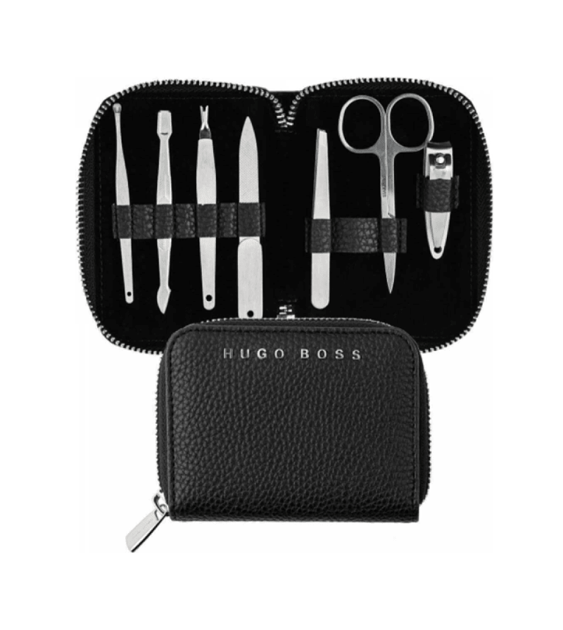 HUGO BOSS manicure and pedicure nail care set with skin scissors, nail clipper, and tweezers on a white background.