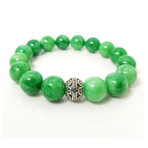 Green Jadeite beaded bracelet with 12mm beads from T.M.J, featuring a stretchy design and natural green gemstone appearance.