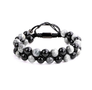 T.M.J Hawk Eye and Onyx macramé beaded bracelet with black and blue stones and intricate knot detailing.