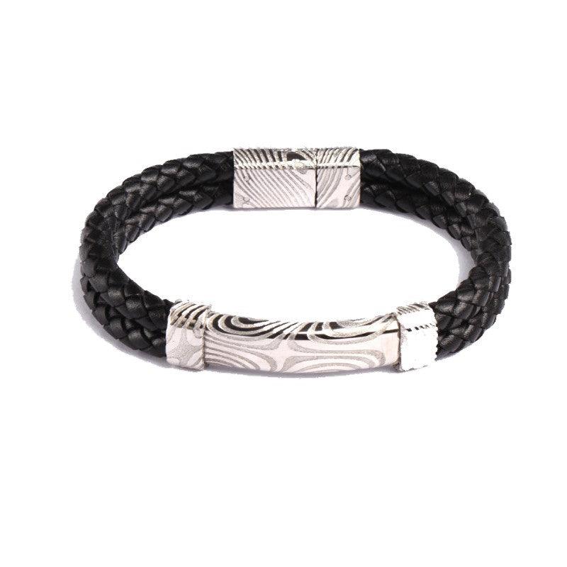 Damascus steel and leather bracelet from T.M.J, featuring a sleek leather band with Damascus steel accents.