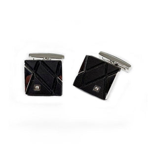 Elegant stainless steel and carbon fiber cufflinks with cubic zirconium accents, showcasing a sleek, modern design by T.M.J.
