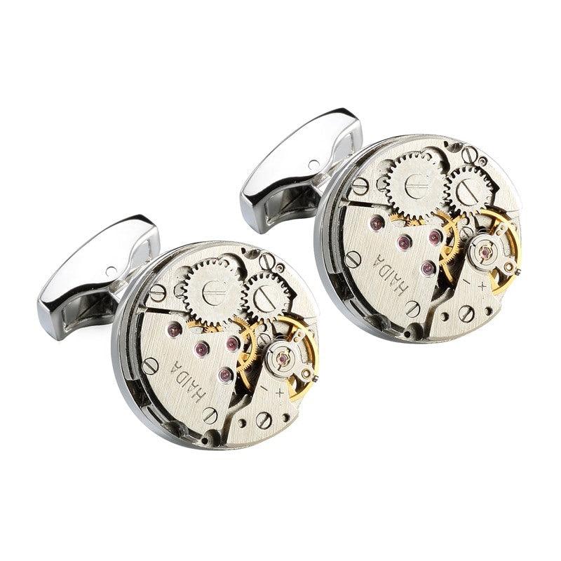 Silver cufflinks featuring vintage mechanical watch movements by T.M.J, showcasing intricate watch parts and classic design.