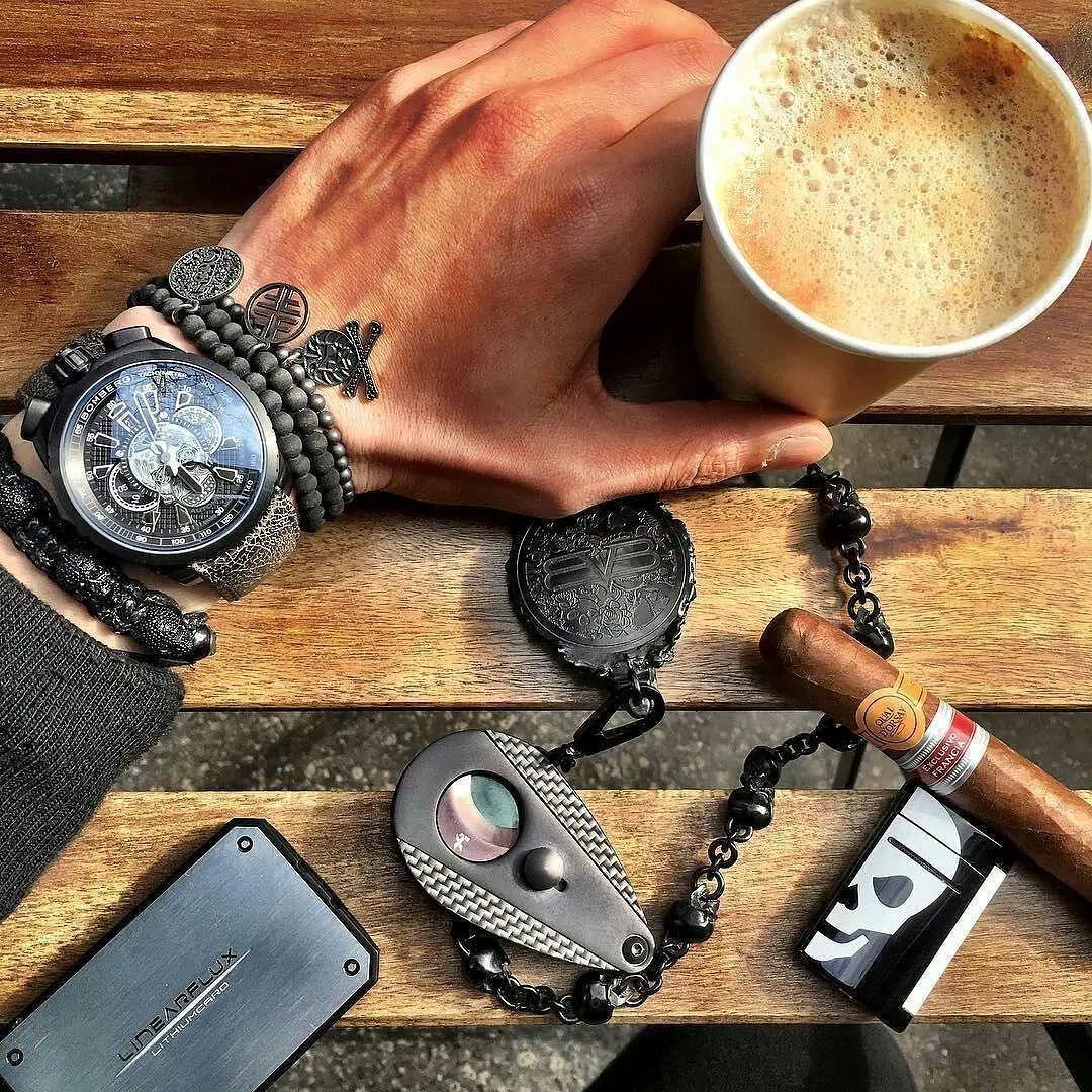 Men's watch styled with black beaded and leather bracelets