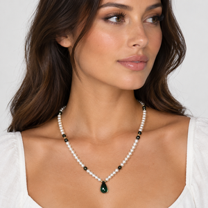 Model wearing the cultured pearl necklace with 14k gold spacers and a green briolette tourmaline drop