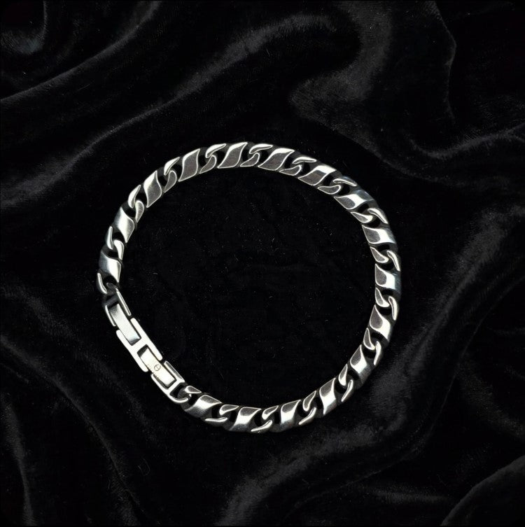 Titan Flat Cuban Curb Chain Bracelet in stainless steel, T.M.J. metal bracelet with flat Cuban links visible in the image.