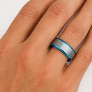 8mm Silver and Polished Blue Tungsten Carbide Ring on hand, showcasing its brushed silver exterior and sleek blue interior design.