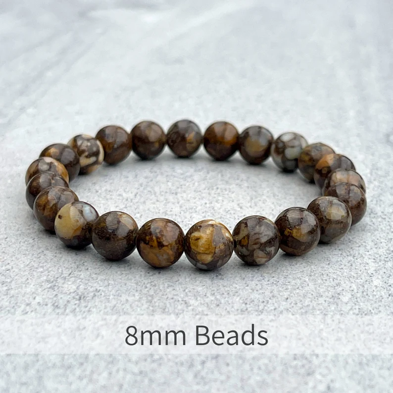 Fire Lace Opal beaded bracelet with 8mm natural stones on a flat surface.