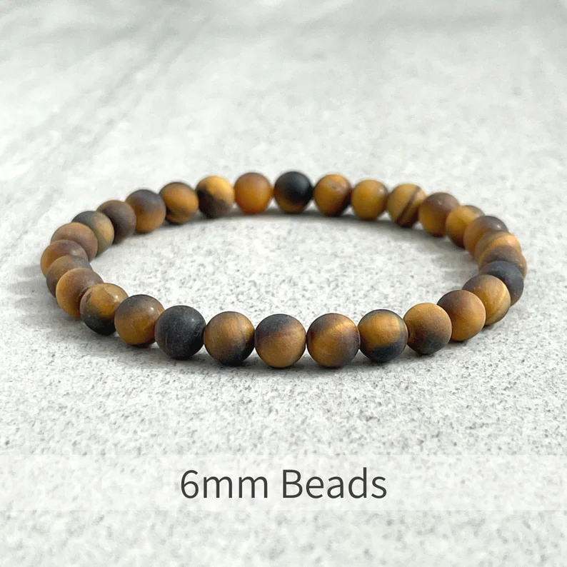 Matte Tiger Eye bead bracelet with 10mm elastic and gold-plated spacer, handcrafted.
