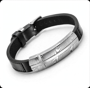 Damascus steel and black leather bracelet from T.M.J, featuring woven metal and leather band with adjustable clasp.