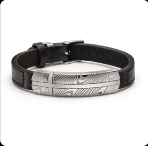 Damascus steel and black leather bracelet by T.M.J featuring intricate metalwork and sleek leather band.