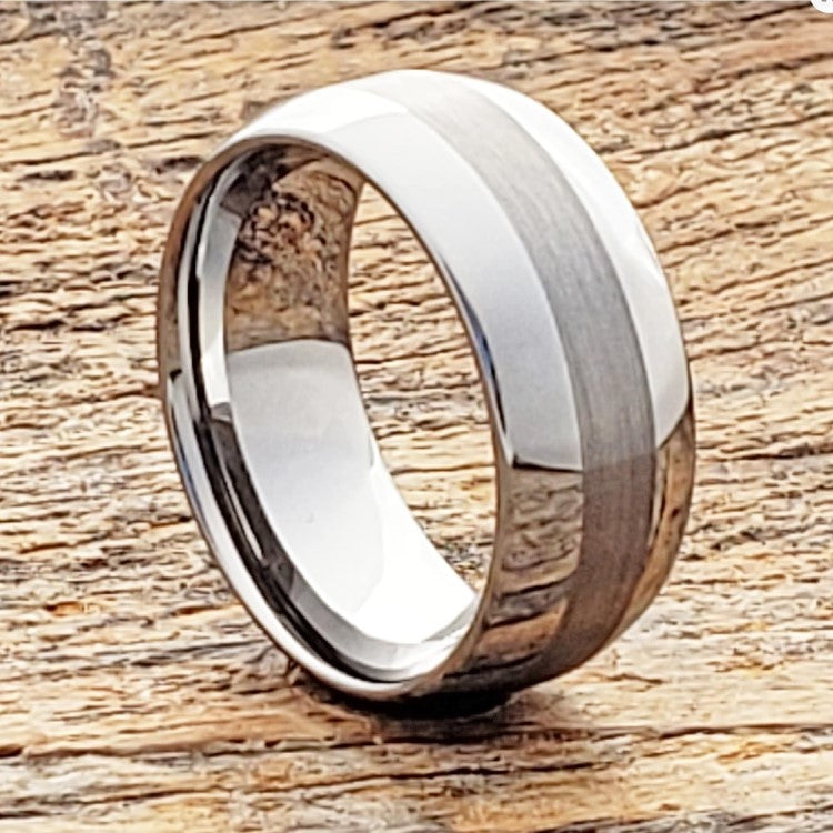 8mm silver tungsten carbide ring with satin finish and polished edges on wood surface.