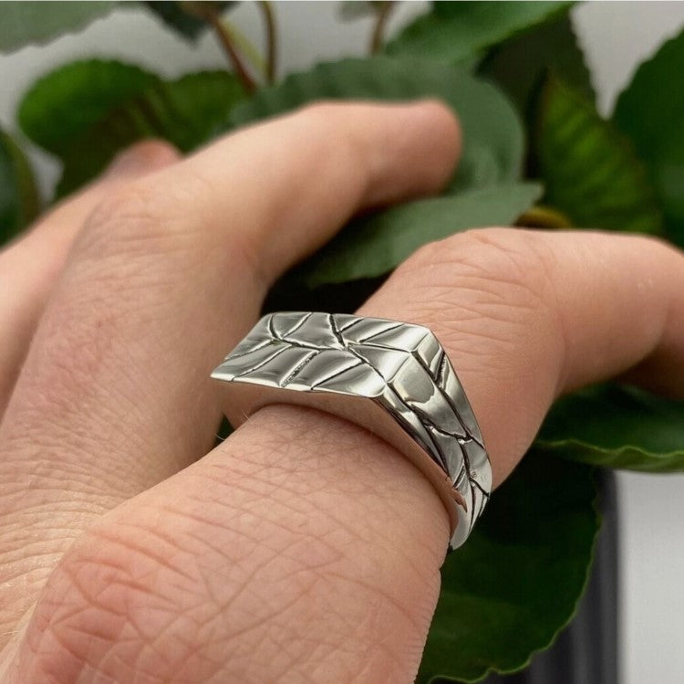 Men's stainless steel ring with unique "crazy pattern" finish shown on finger.