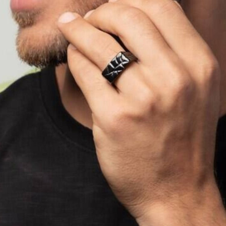 Men's stainless steel ring with unique crazy pattern finish, worn by a model.