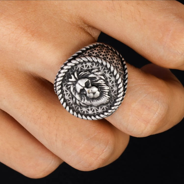 Antique Lion Head ring with detailed relief design on a finger, showcasing strength in stainless steel.