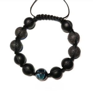 Lava agate and tiger eye beaded macramé bracelet by T.M.J, featuring natural stone beads and intricate knotting details.