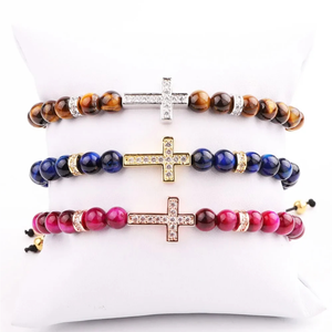 Natural 6mm Tiger Eye beaded bracelet with CZ cross charm, featuring macrame cord, by T.M.J. for stylish accessory wear.