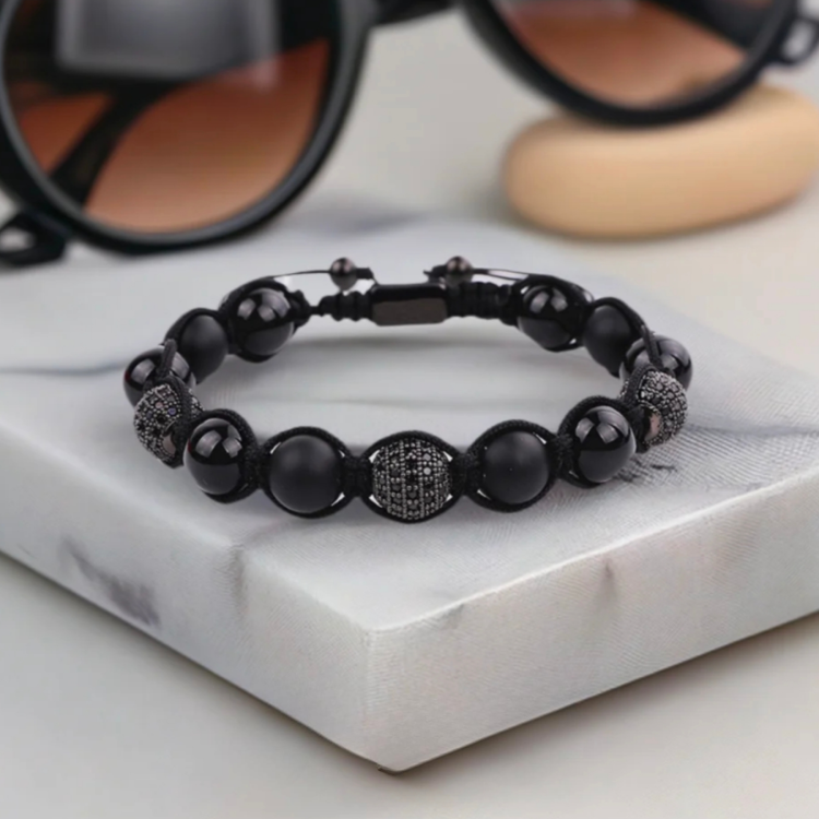 Natural stone onyx and tiger eye beaded macrame bracelet by T.M.J, showcasing detailed craftsmanship and vibrant gemstone beads.