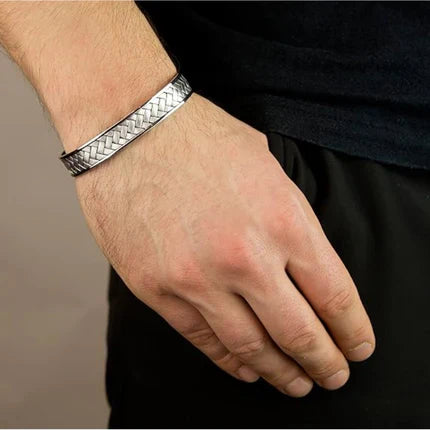 Sterling silver woven pattern cuff bangle on wrist, showcasing bold herringbone texture and modern sophistication.