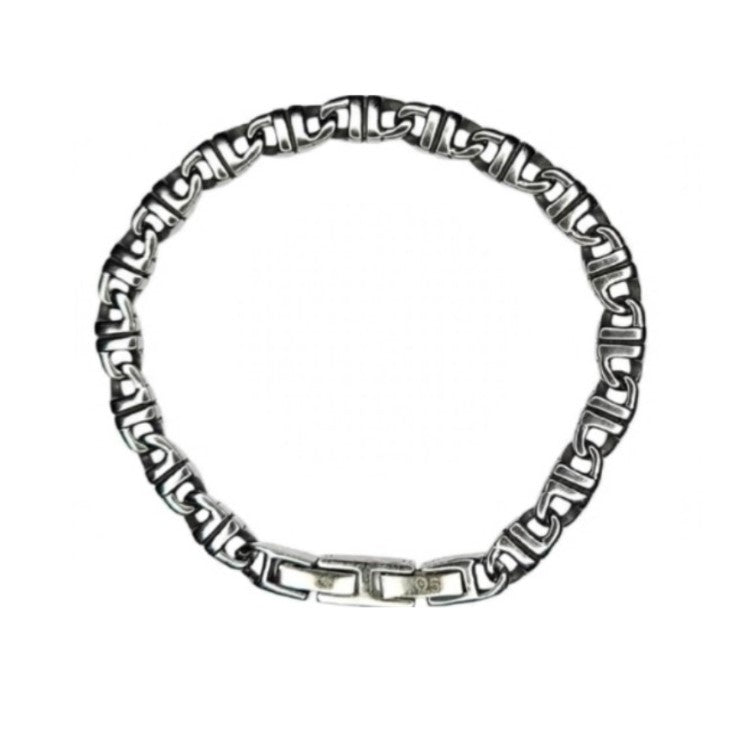 T.M.J Meridian Balinese J-Link horseshoe stainless steel bracelet with intricate metal design on a neutral background.