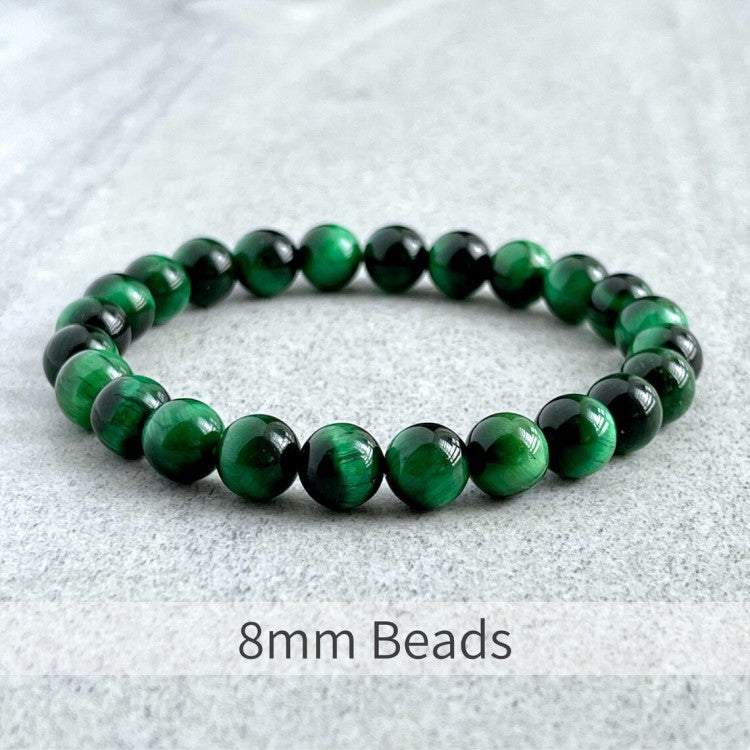 Green Tiger Eye bead bracelet with 8mm beads, elastic strand, and stainless steel spacer.