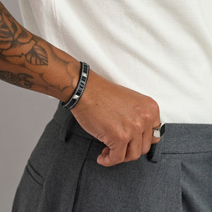 T.M.J Kairos black onyx beaded bracelet with silver accents, featuring silver lock and black onyx beads for a stylish men's jewelry look.