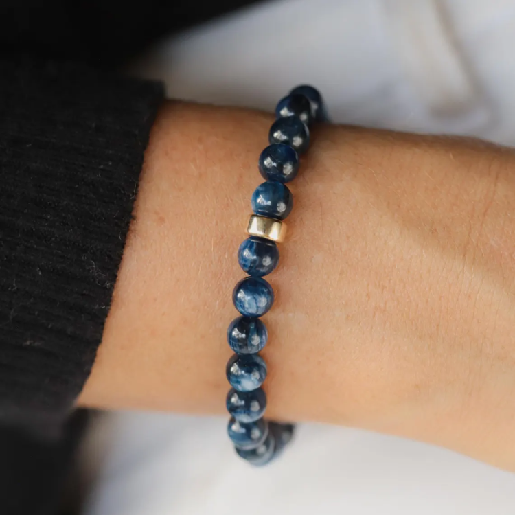 Dark blue 7.5mm Kyanite crystal beaded bracelet by T.M.J, featuring plain round beads on a stretch elastic band.