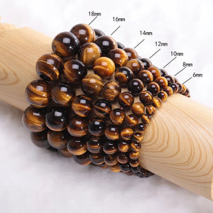 Tiger Eye and silver bead bracelet by T.M.J, featuring 17mm tiger eye and 4mm silver beads, styled as a beaded bracelet.
