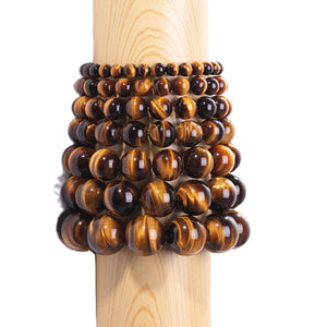 Tiger Eye and silver bead bracelet featuring 17mm and 4mm beads from T.M.J, showcasing polished tiger eye stones and silver accents.