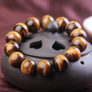 Tiger Eye and silver bead bracelet by T.M.J, featuring 17mm and 4mm beads, showcasing natural stone and metallic accents.