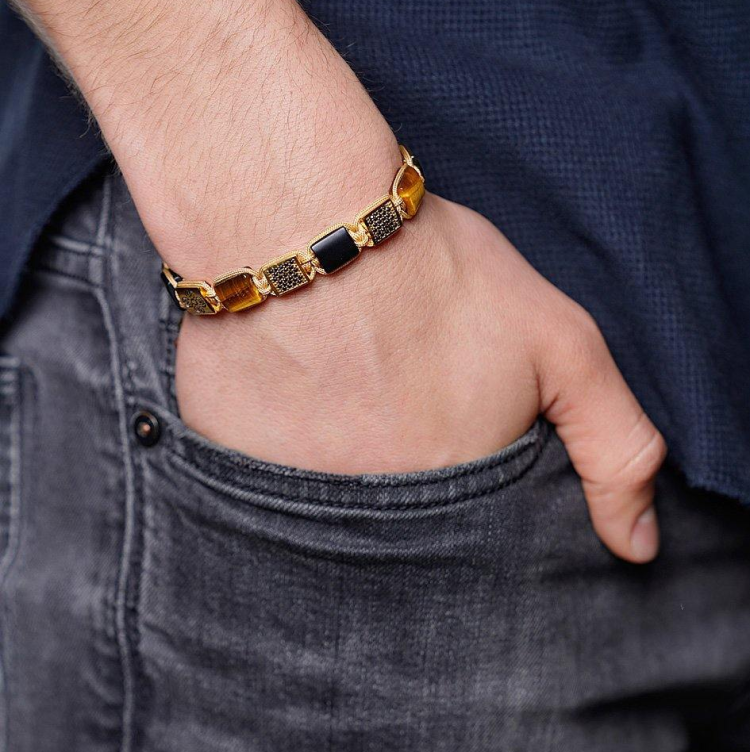 T.M.J Eye of Dharma flatbead bracelet with matte onyx and brown tiger eye beads, showcasing a stylish beaded jewelry design.