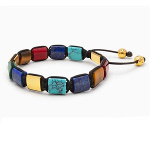 T.M.J Eye of Dharma flat bead bracelet featuring turquoise, tiger eye, lapis lazuli beads with gold accents.