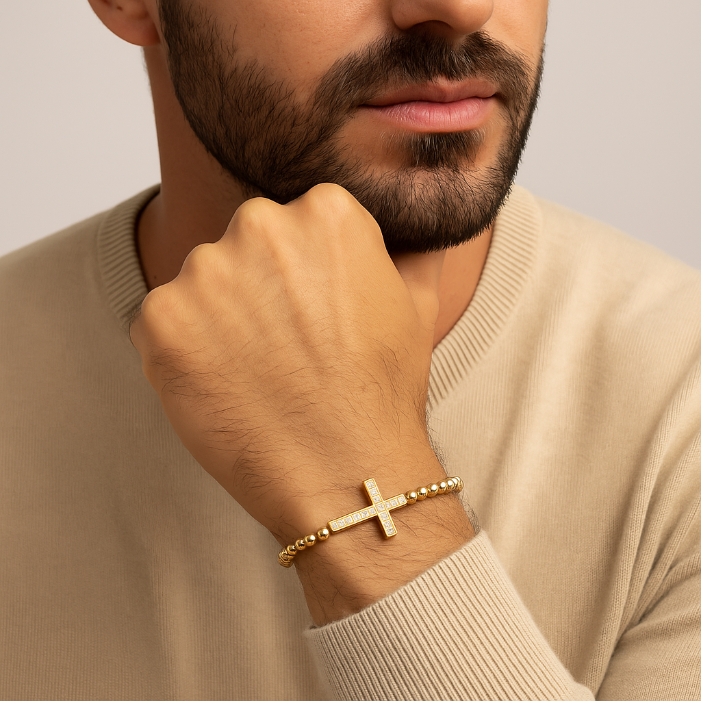 Gold beaded macrame bracelet with a luxury CZ diamond cross charm by T.M.J, featuring intricate bead details.