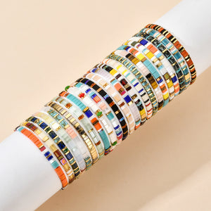 T.M.J Tila Link Macrame Bracelet with white gold Miyuki Tila beads, featuring intricate beadwork and adjustable macrame design.