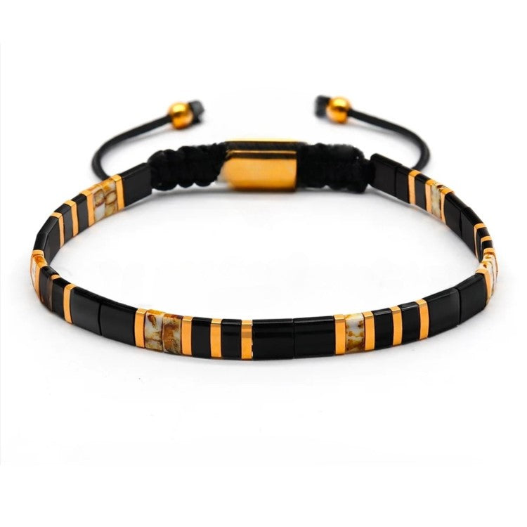 T.M.J Tila Link Macrame Bracelet with white and gold Miyuki Tila beads, featuring intricate beadwork and adjustable cord.