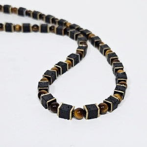 T.M.J beaded necklace featuring black lava and tiger eye stones, 50cm length with natural gemstone details.