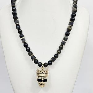 Large silver and gold-plated skull pendant with crown on blue tiger eye beaded necklace by T.M.J.