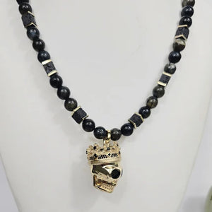 Large silver and gold-plated skull with crown pendant on blue tiger eye beaded necklace, T.M.J beaded jewelry.