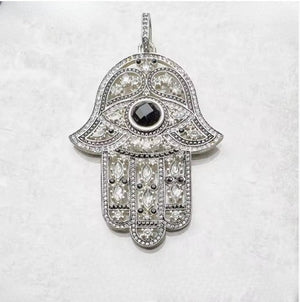 Large silver Hand of Hemsa pendant with Austrian crystals on matte onyx beaded necklace by T.M.J, close-up view of the necklace.