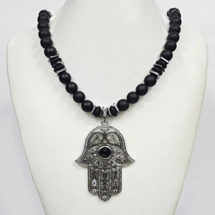 Large silver Hand of Hemsa pendant on T.M.J beaded necklace with Austrian crystals and matte onyx beads.