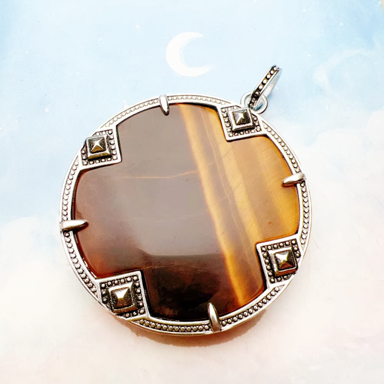 Large silver tiger eye pendant on beaded turquoise and tiger eye necklace by T.M.J, showcasing detailed stone craftsmanship.
