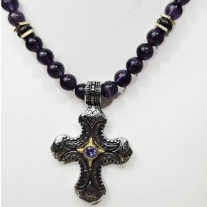 Stainless steel cross pendant with amethyst crystal strand on a beaded necklace, featuring purple amethyst beads and T.M.J branding.