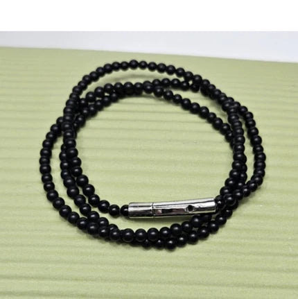 Black Onyx beaded necklace with silver and gold honey bee pendant, featuring elegant jewelry design by T.M.J.