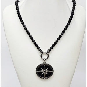 Black Onyx beaded necklace with silver and onyx North Star pendant, featuring smooth black beads and a detailed star-shaped charm.