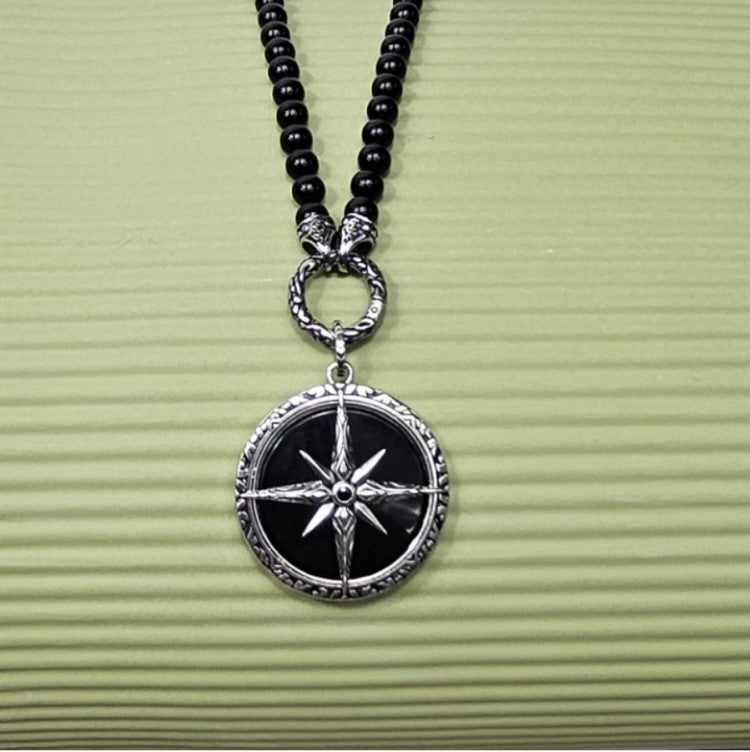 Black Onyx beaded necklace with silver and Onyx North Star pendant, featuring polished beads and a star-shaped pendant.