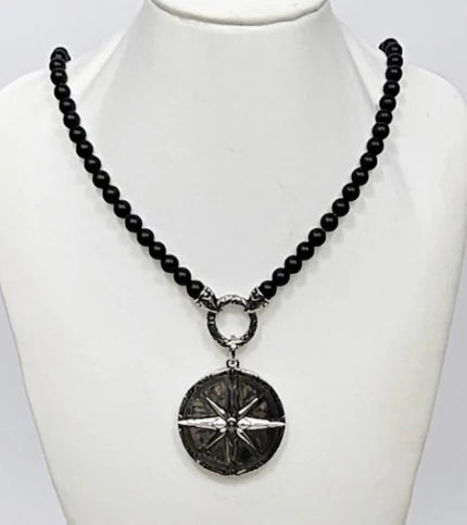 Black Onyx beaded necklace with silver and Onyx North Star pendant, featuring a detailed pendant design on a beaded chain.