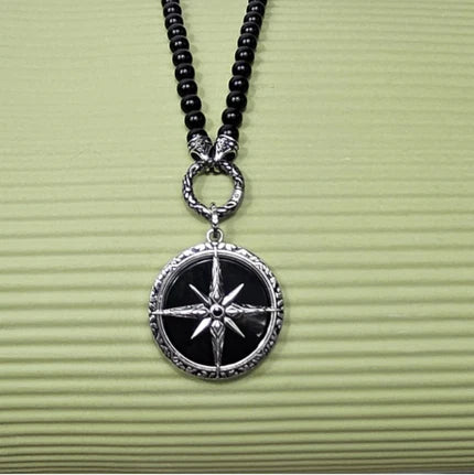 Black Onyx beaded necklace with silver and Onyx North Star pendant, featuring a close-up of the pendant and beaded chain.