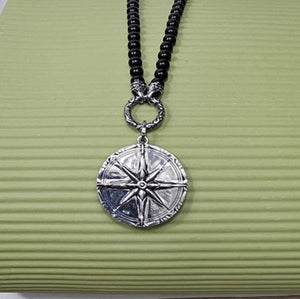 Black Onyx beaded necklace with silver and Onyx North Star pendant, featuring a close-up of the pendant detail and beaded chain.