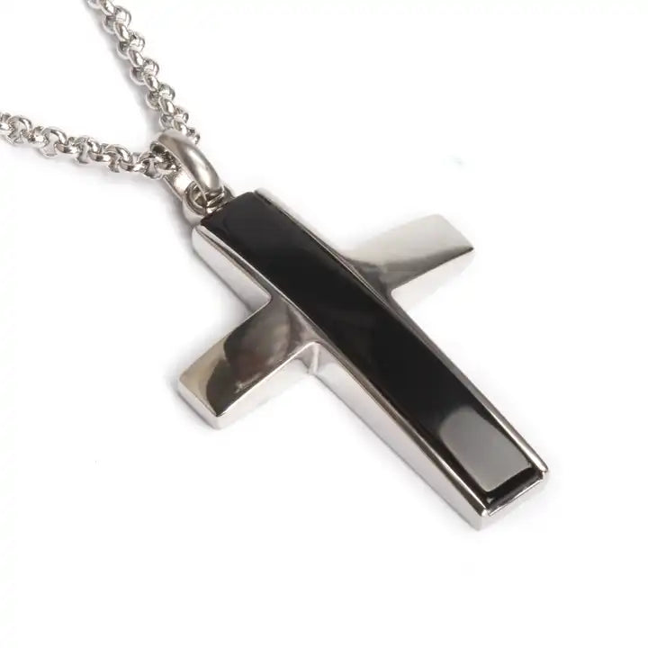 Stainless steel cross pendant necklace with black onyx inlay, T.M.J brand, hanging on a chain with detailed design.